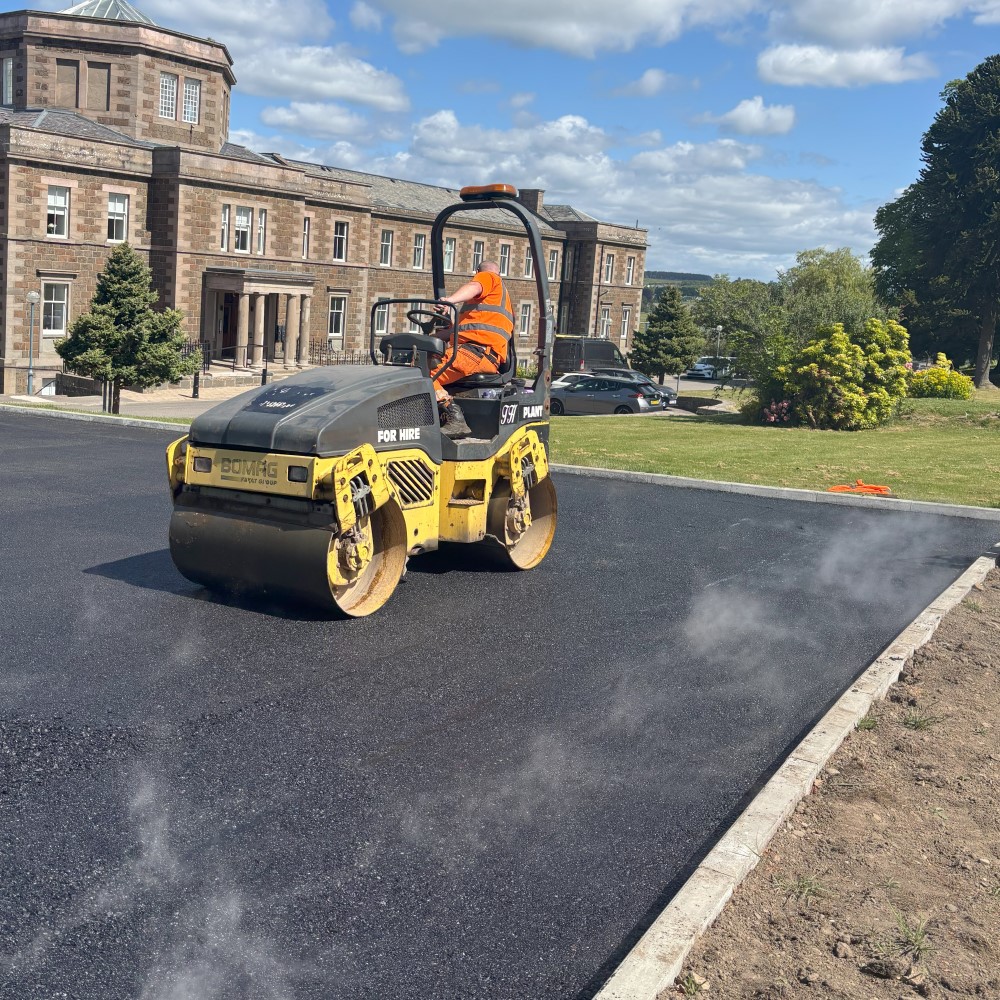 Rolling the hot tar.