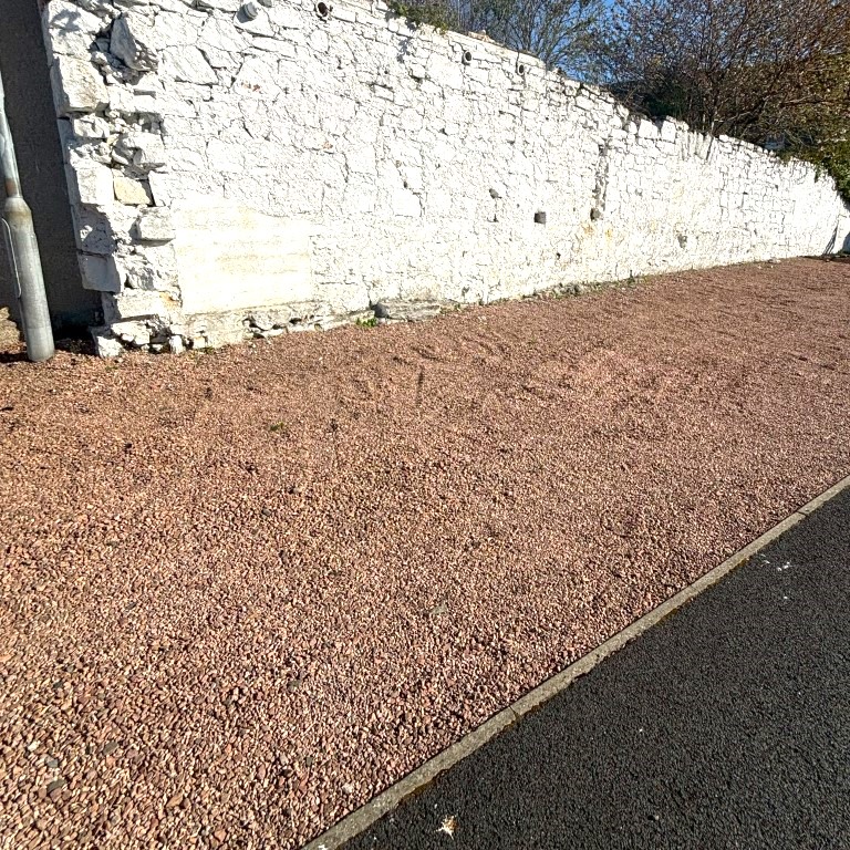Area of pink chips in front of a white wall