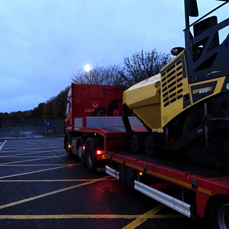 Trevor Harris' Bomag Paver on our loader waiting to get in to a yard. Early morning