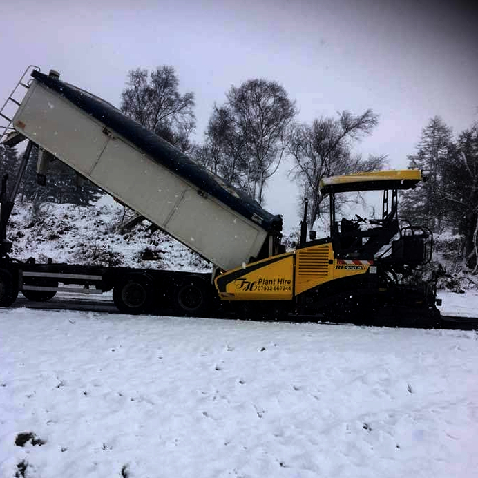 Trevor Harris paver taking a tip in the snow